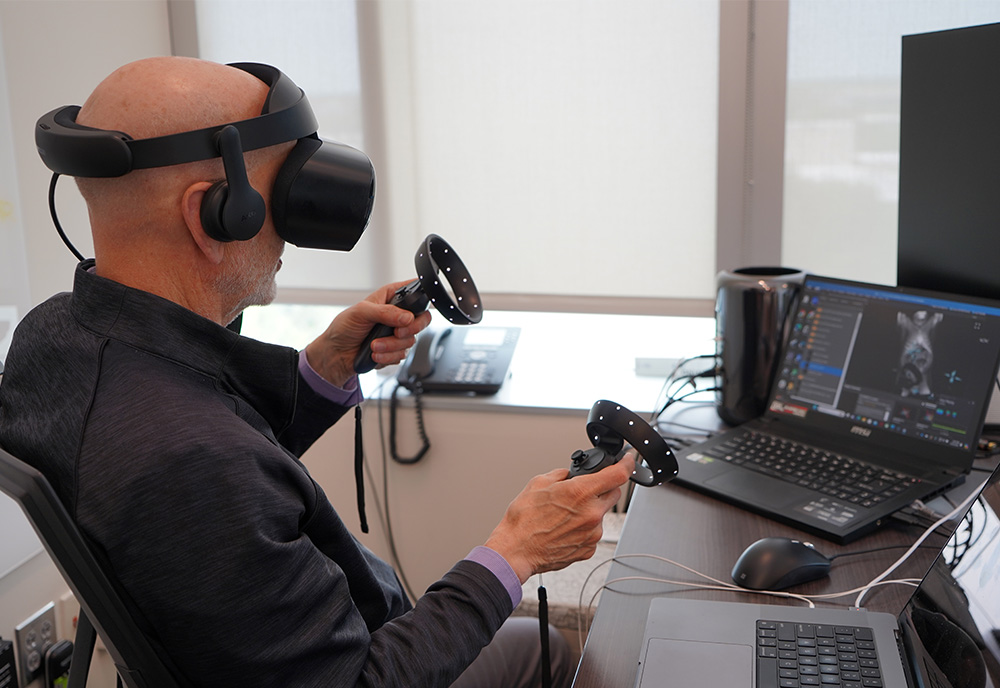 George Spirou using a VR set paired with the software he created to intricately explore neurons in the body.
