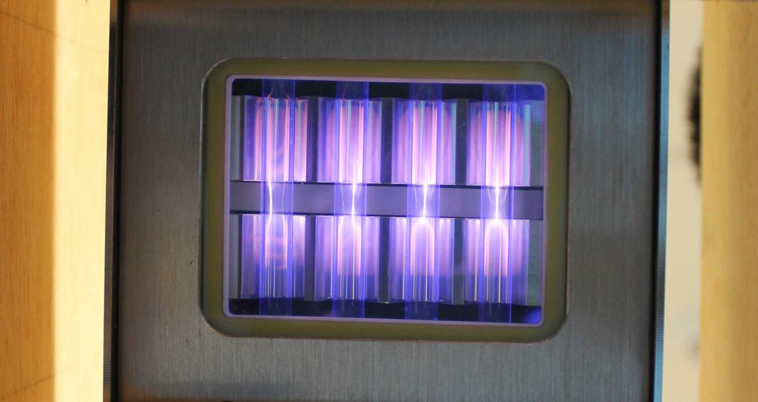 UV light being emitted by a krypton chloride excimer lamp, fueled by molecules moving between different states of energy. (Credit: Linden Research Group) 