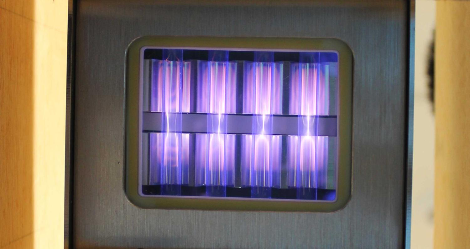 UV light being emitted by a krypton chloride excimer lamp, fueled by molecules moving between different states of energy. (Credit: Linden Research Group)