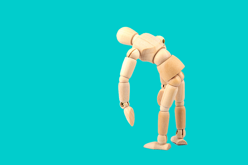 A wooden mannequin poses.