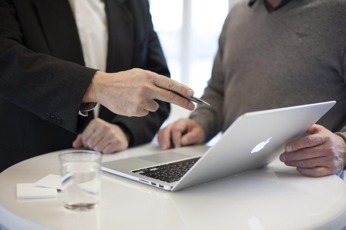 man pointing at laptop