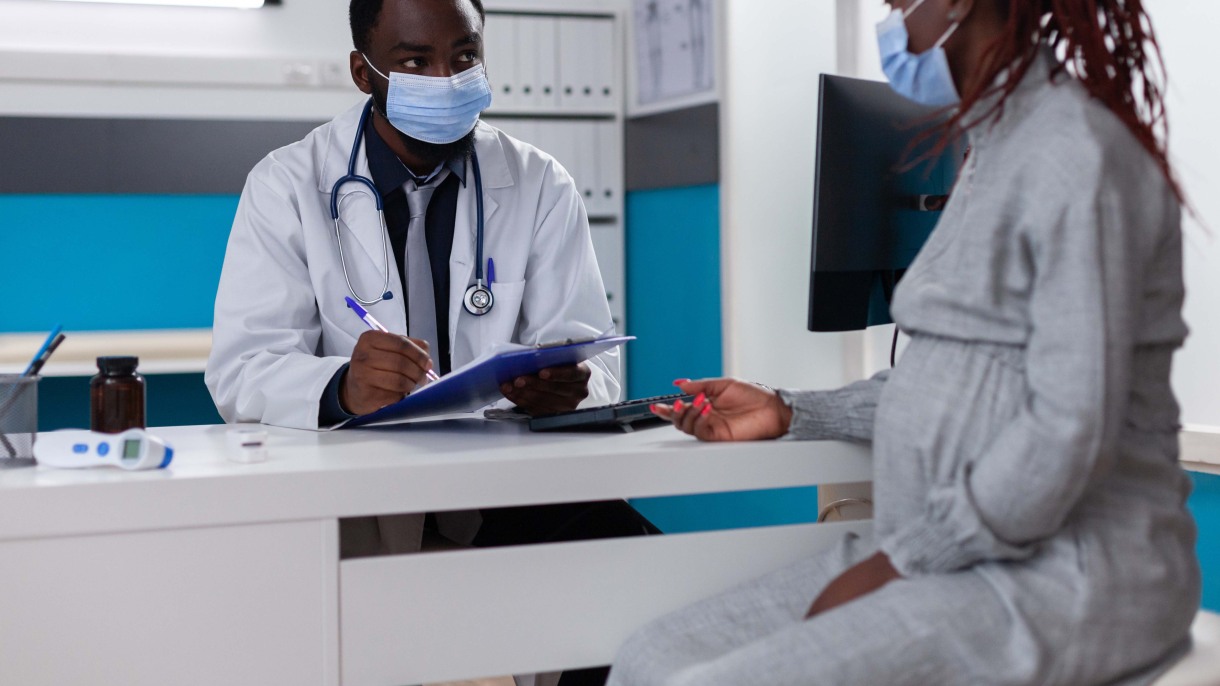 Doctor and patient wearing masks at an appointment