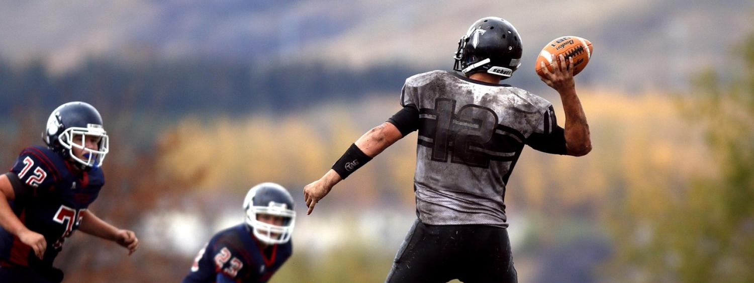 A quarterback lines up his throw.