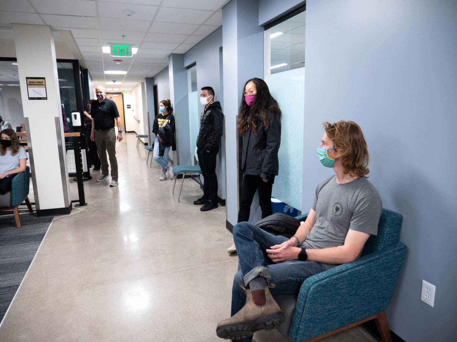 CU Boulder students wait in a campus building