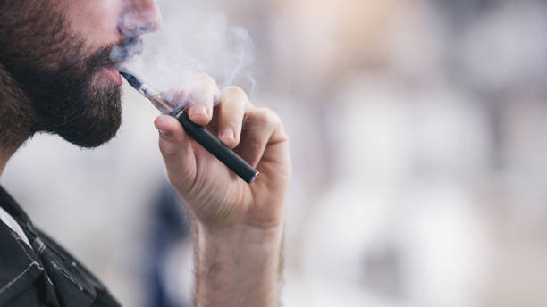 A man smoking an e-cigarette