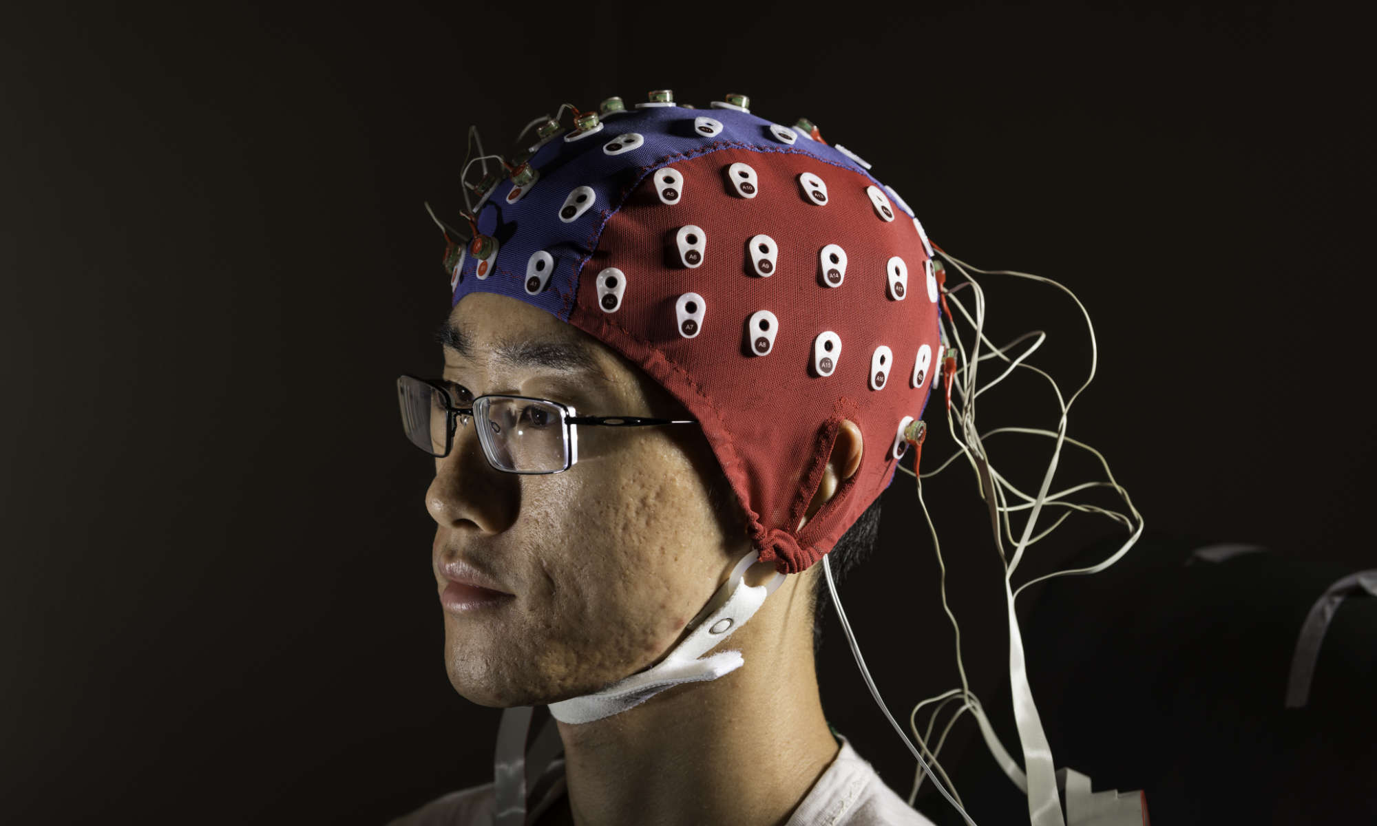 Man wearing an electroencephalography cap to measure the brain's electrical activity