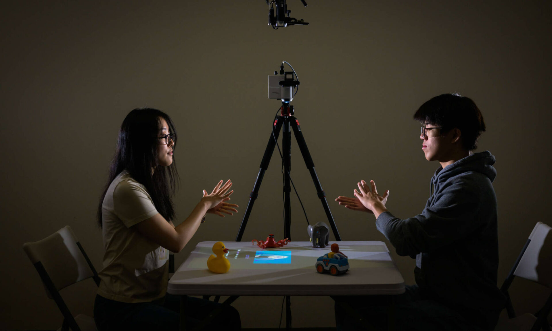 University of Rochester graduate student Yifan Li (left) and undergraduate Wenyao Gao ’26 test the Tabletop Interactive Play System (TIPS)