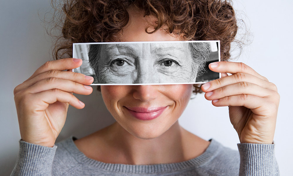 woman holding picture, symbolizing a long lifespan