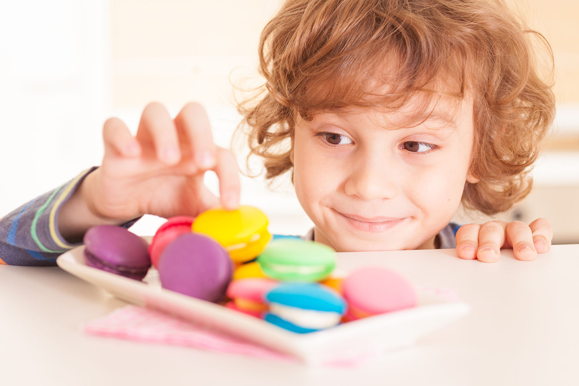 Child exhibiting a lack of self-control, taking a cookie