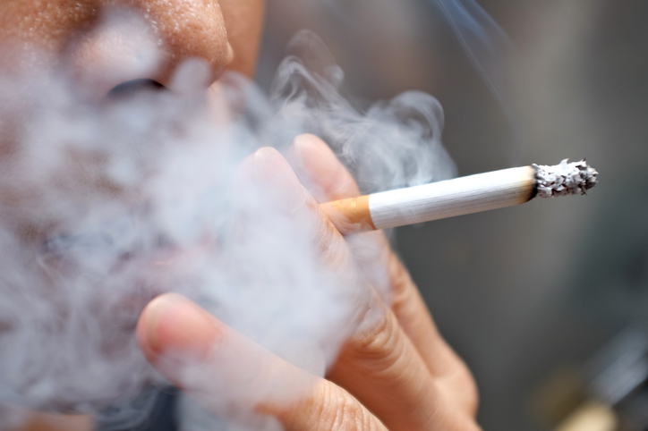 smoking cessation depicted by a smoker with cigarette in hand