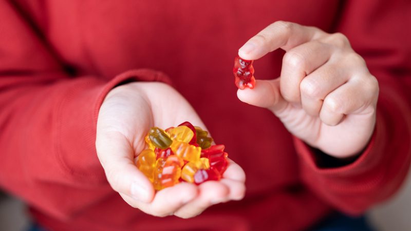 Person consuming an oral nicotine gummy