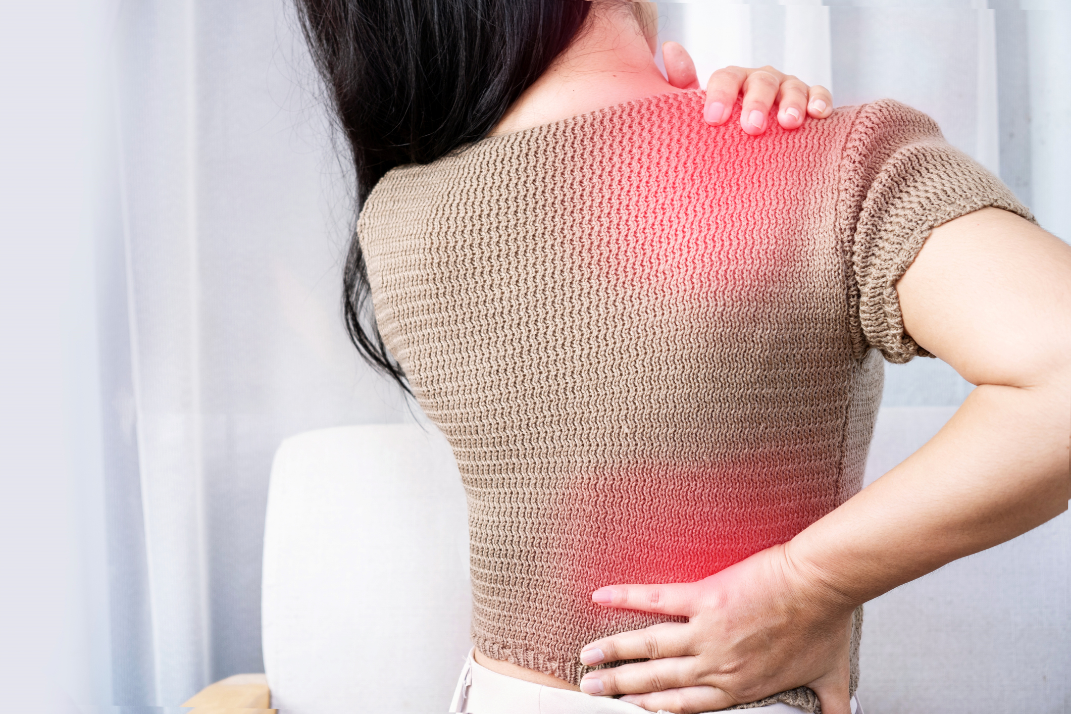 Woman holding her back in pain