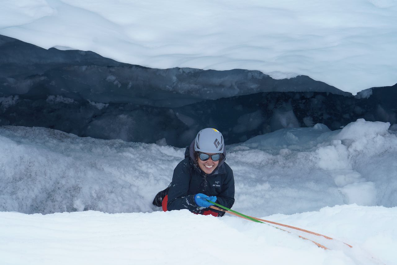 Randall being lowered into a crevasse, held up by an anchor system built into the snow. A haul team then hoisted her up, one of the skills taught to students during the safety training weeks at JIRP. Photo credit: Matt Skorina.