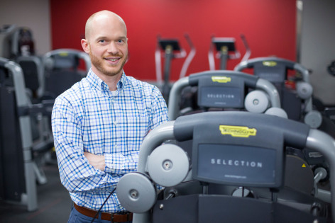 Jacob Meyer poses by a treadmill.