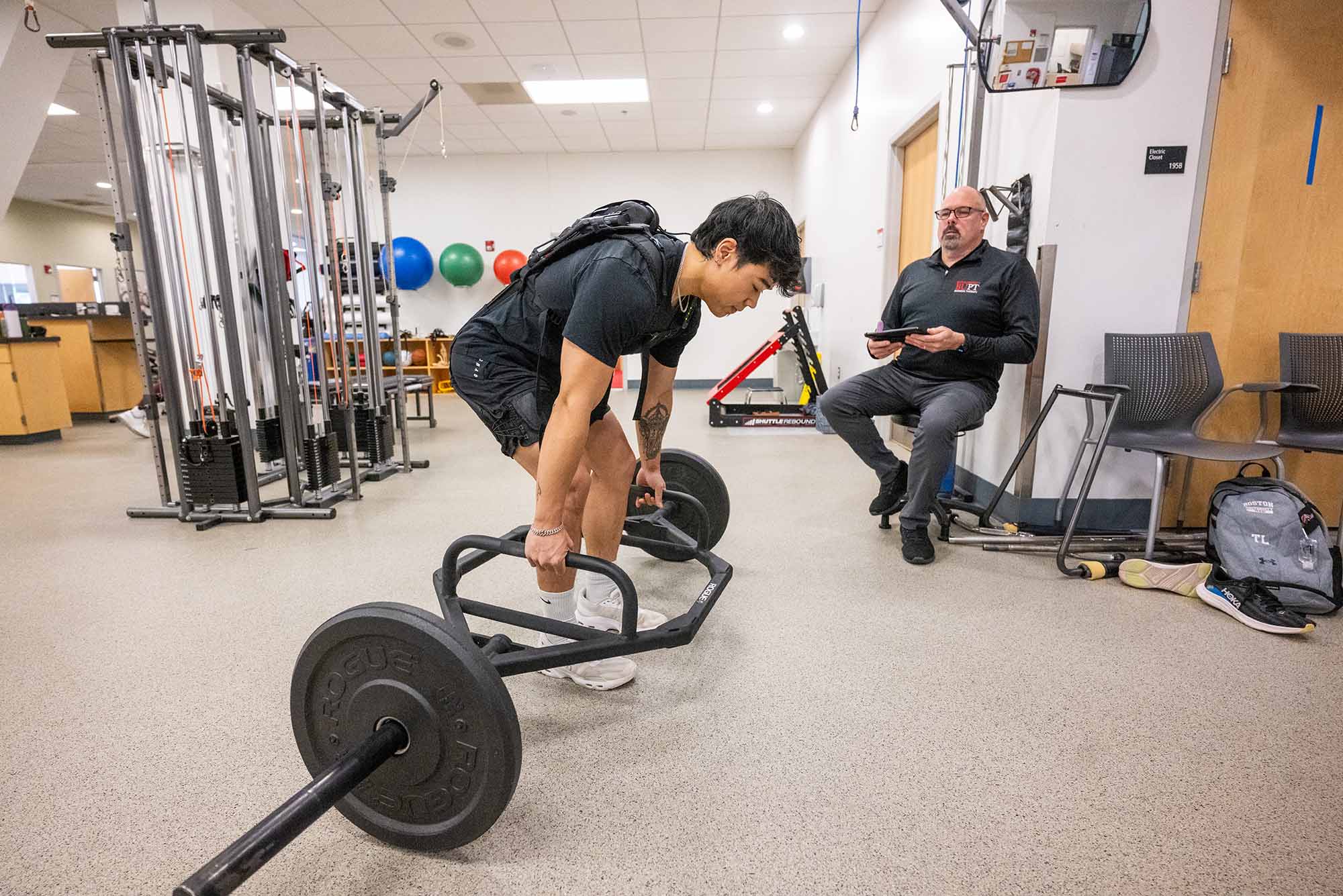 Physical therapy staffer lifting weights for low back pain research