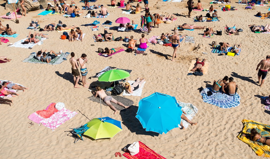 People increase their melanoma risk on the beach.