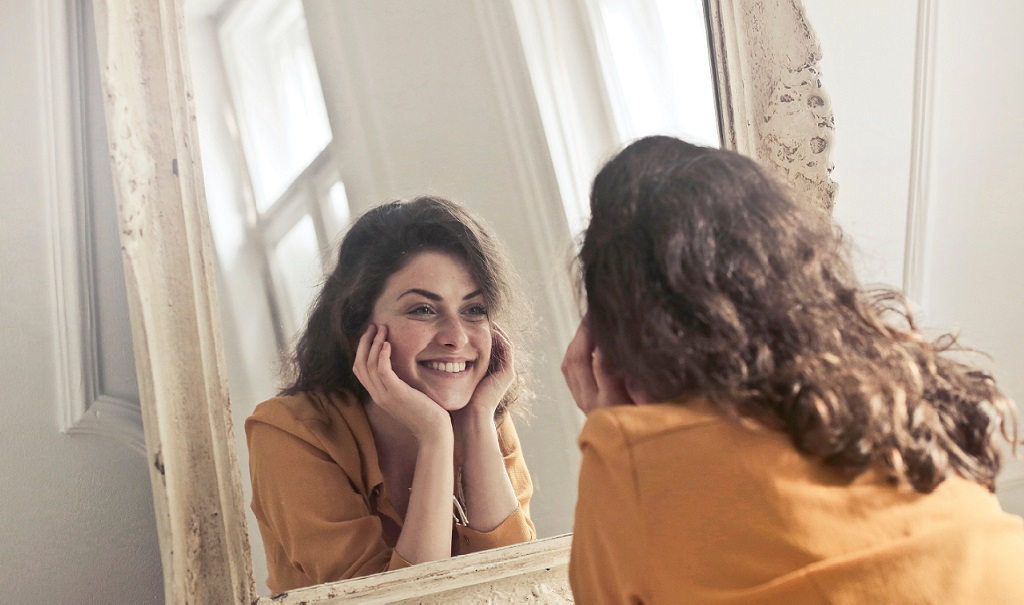 A person admires their reflection.