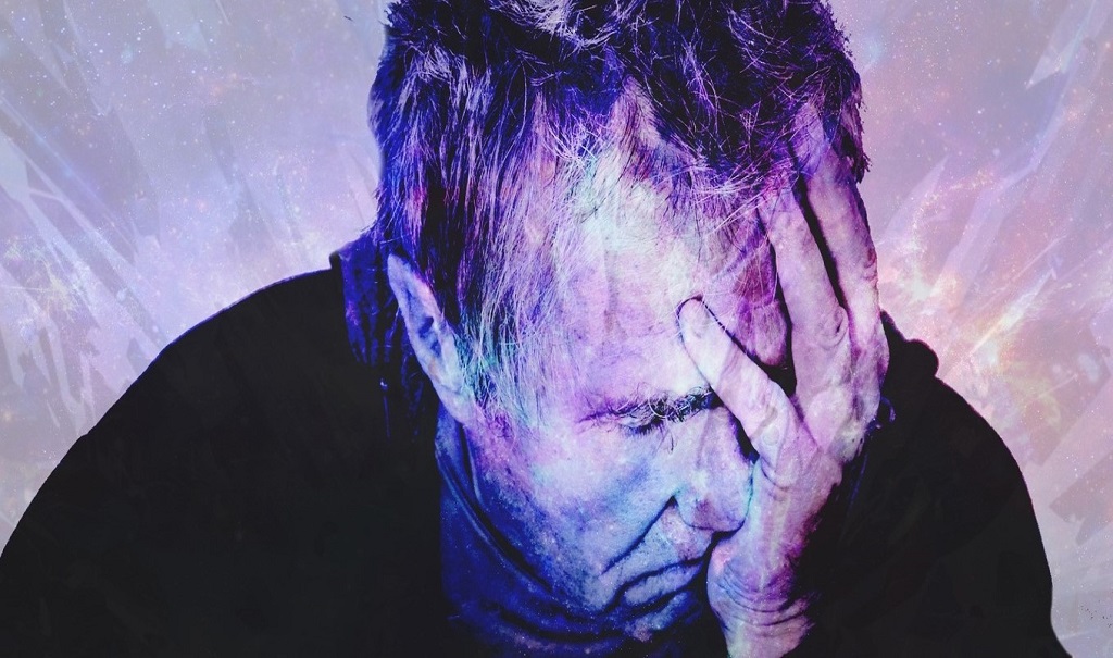 A person holds their head in one hand.