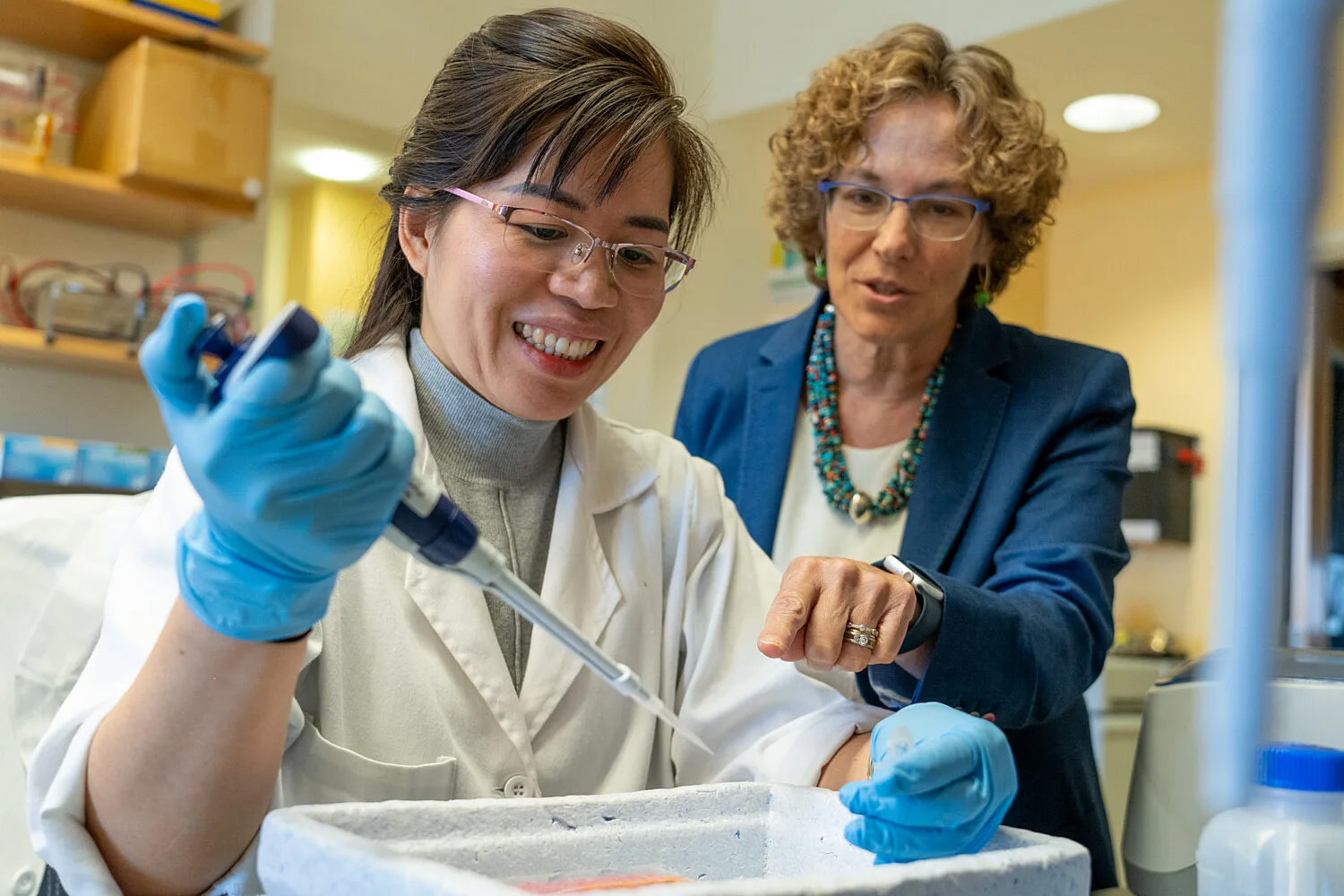 Neurogeneticists using lab equipment
