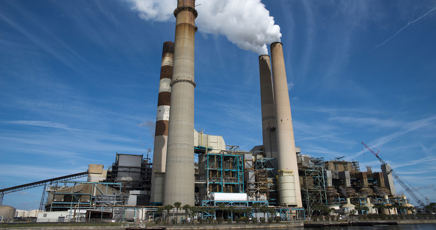 Cooling towers spew smoke into the atmosphere.