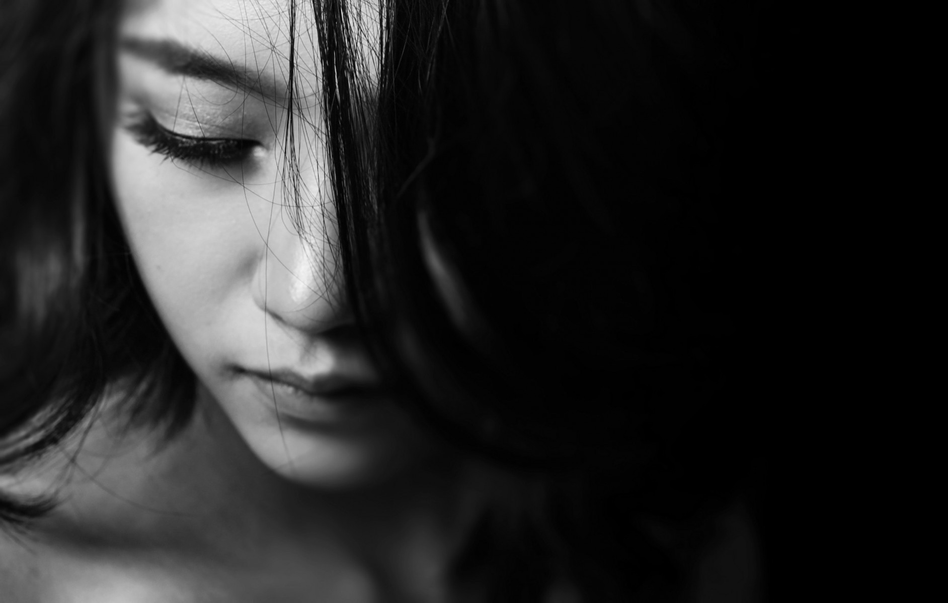 A child poses with hair in front of her face.