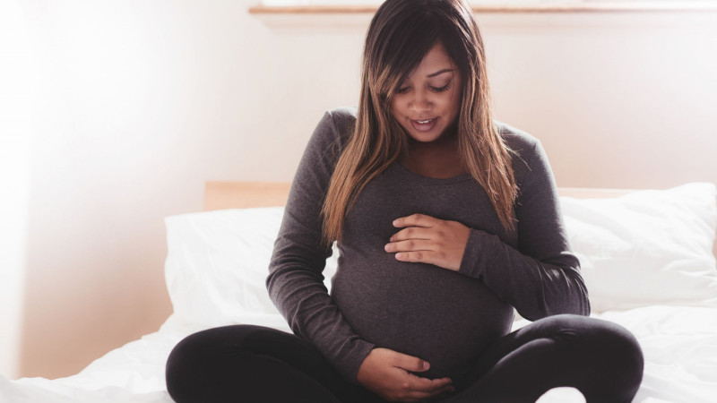 woman looking at her stomach, phthalates