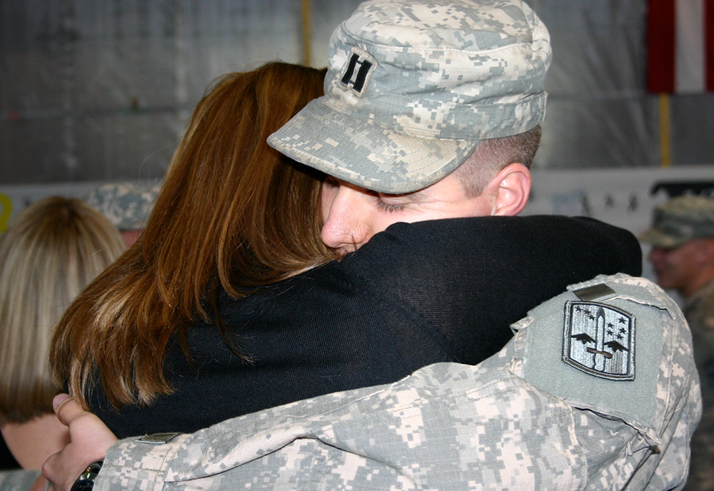 Samantha Tromly, program director of the USF Institute of Applied Engineering, embraces her husband, Maj. Kevin Tromly, following his return from deployment to Iraq