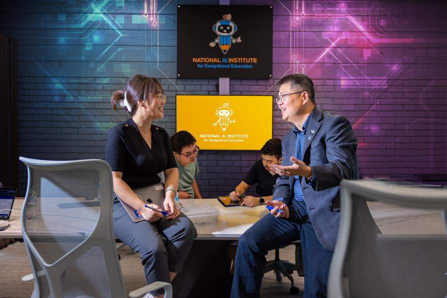 Professor Jinjun Xiong discusses speech disorders with a student