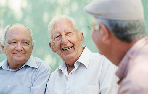 Three men laugh.