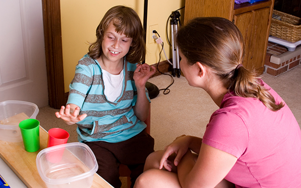 An autistic child with her teacher