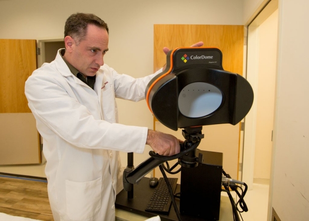 Researcher with a white light cognitive therapy machine.