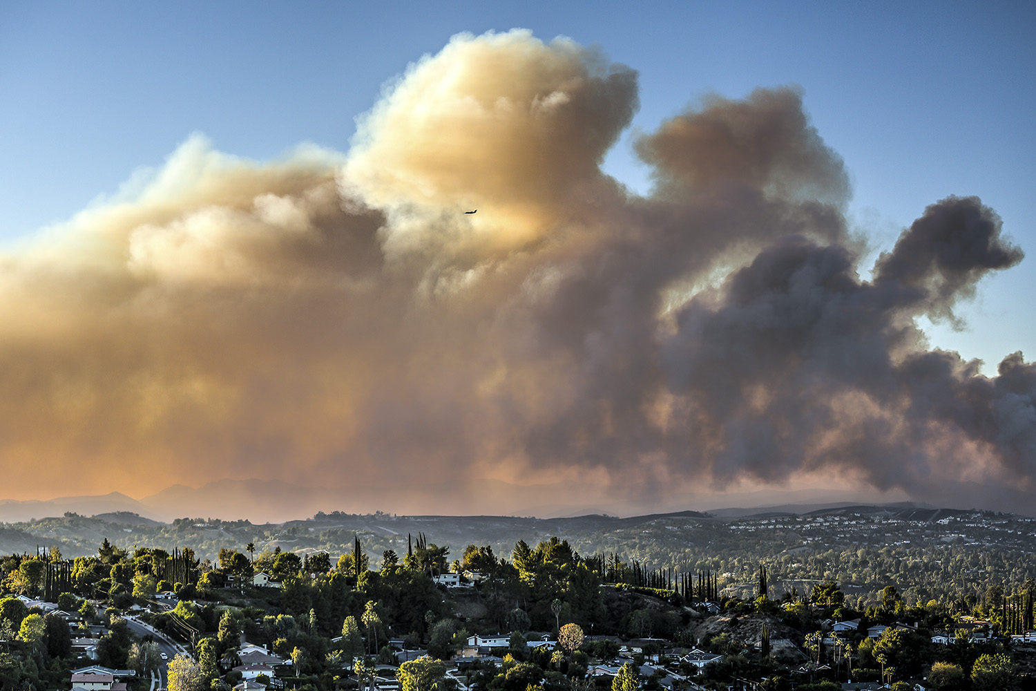 Wildfire smokes rises above city