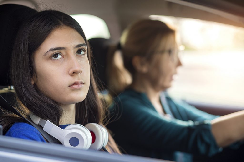 A teen looking away from parent