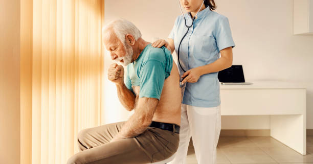 Man in doctor's office coughing due to tuberculosis
