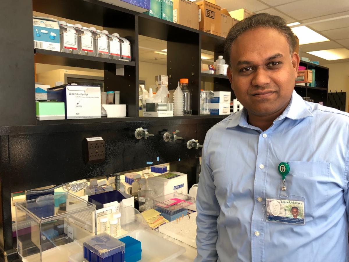 A researcher poses in his lab.