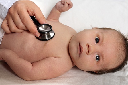 A person uses a stethoscope on a baby.
