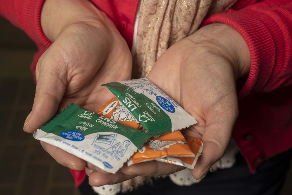 Christine Stewart holds packets of nutrient supplements
