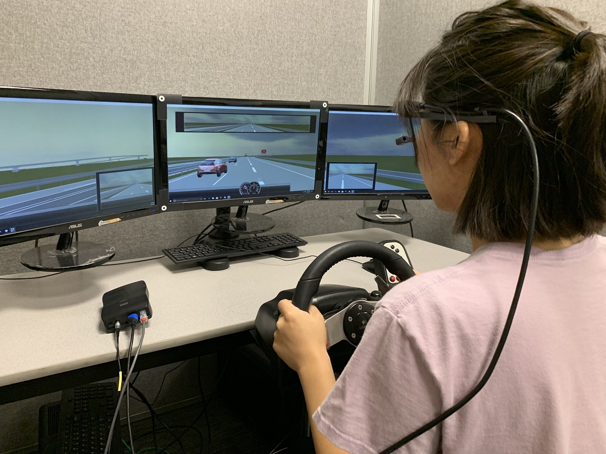 A woman drives during an eye-tracking simulation.