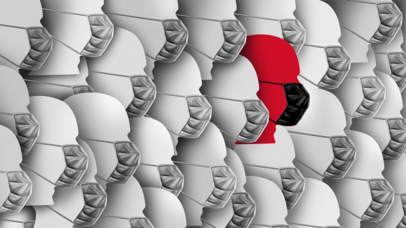 Rows of people wearing face masks - one in red.