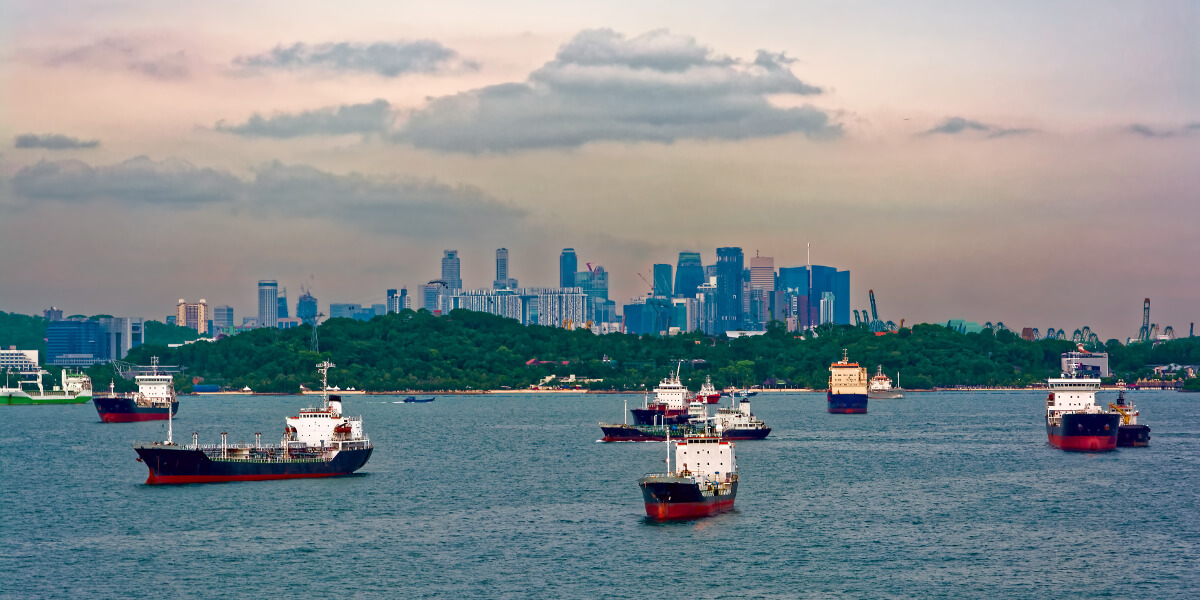 CARGO SHIPS WAITING IN THE HARBOR AT THE BUSIEST PORT OF SINGAPORE