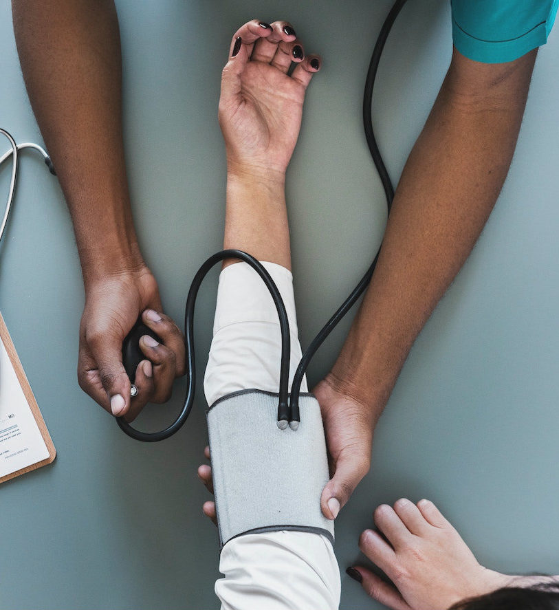 A nurse performs a blood pressure check.