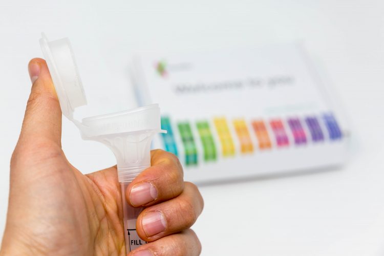 A thumbs up is given to a DNA testing kit.