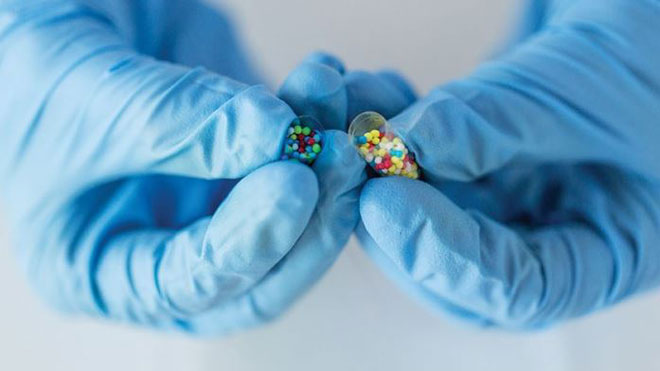 Lab tech holding pill