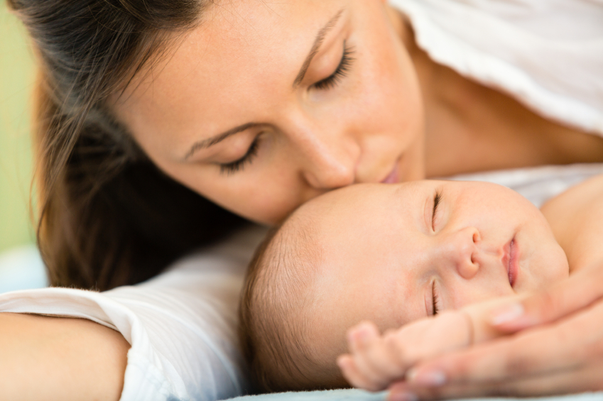 Mother kissing baby