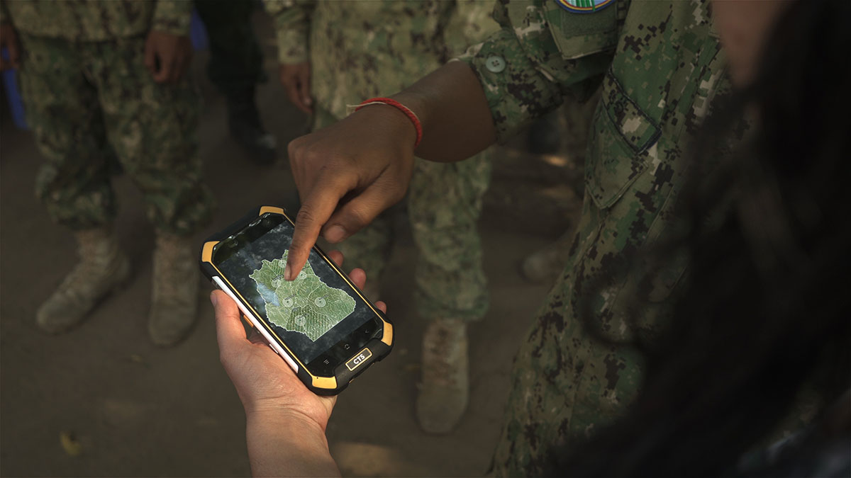 Military personnel look at map of Srepok Wildlife Reserve