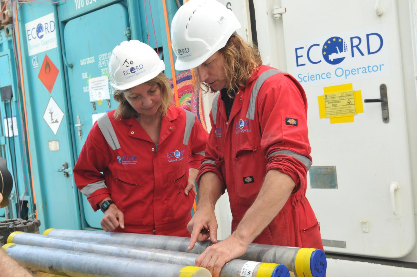 Scientists inspect rock cores.