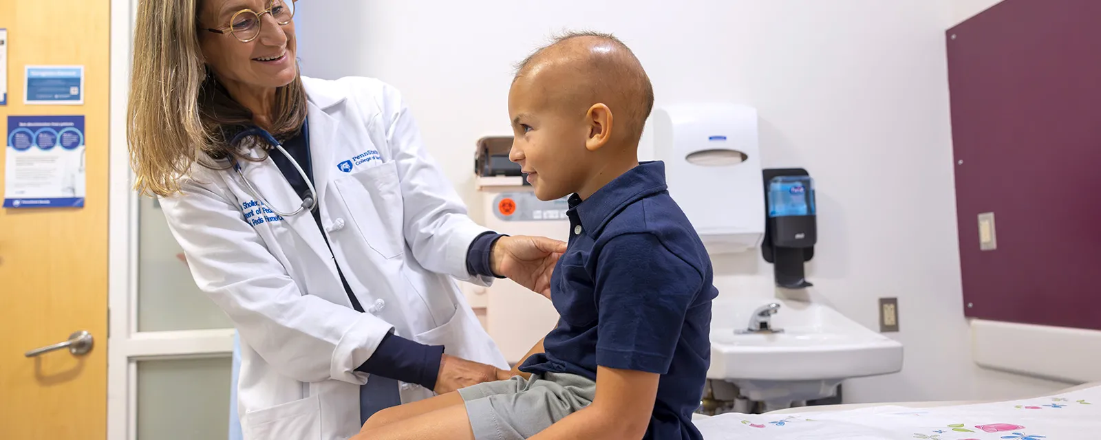 Doctor at Penn State University treating child