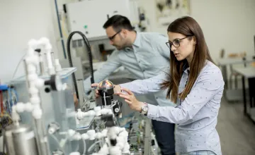 Two researchers in a robotics lab. 