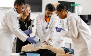 Student nurses practicing CPR with training mannequin