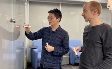 Proposed quantum device may succinctly realize emergent particles such as the Fibonacci anyon; Guangjie Li, graduate student, and Dr. Jukka Vayrynen, assistant professor of physics and astronomy, discuss calculations at the Purdue University Physics Building."